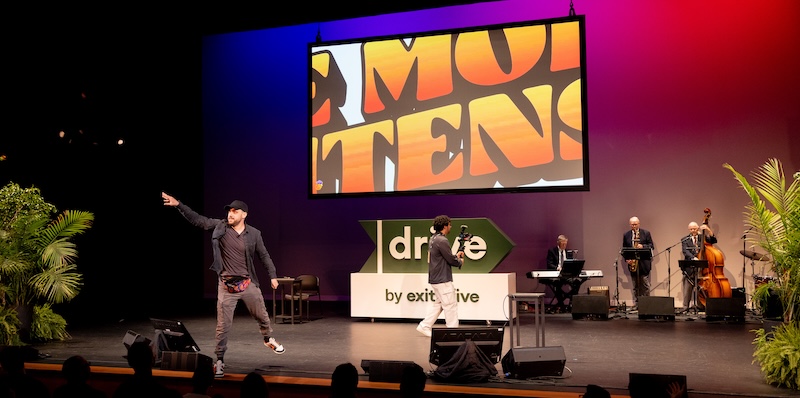 Why B2B Brand Ideas Die a Violent Death Before They Even Launch 1 Louis on stage at Drive 2026 with a jazz quartet revealed behind him