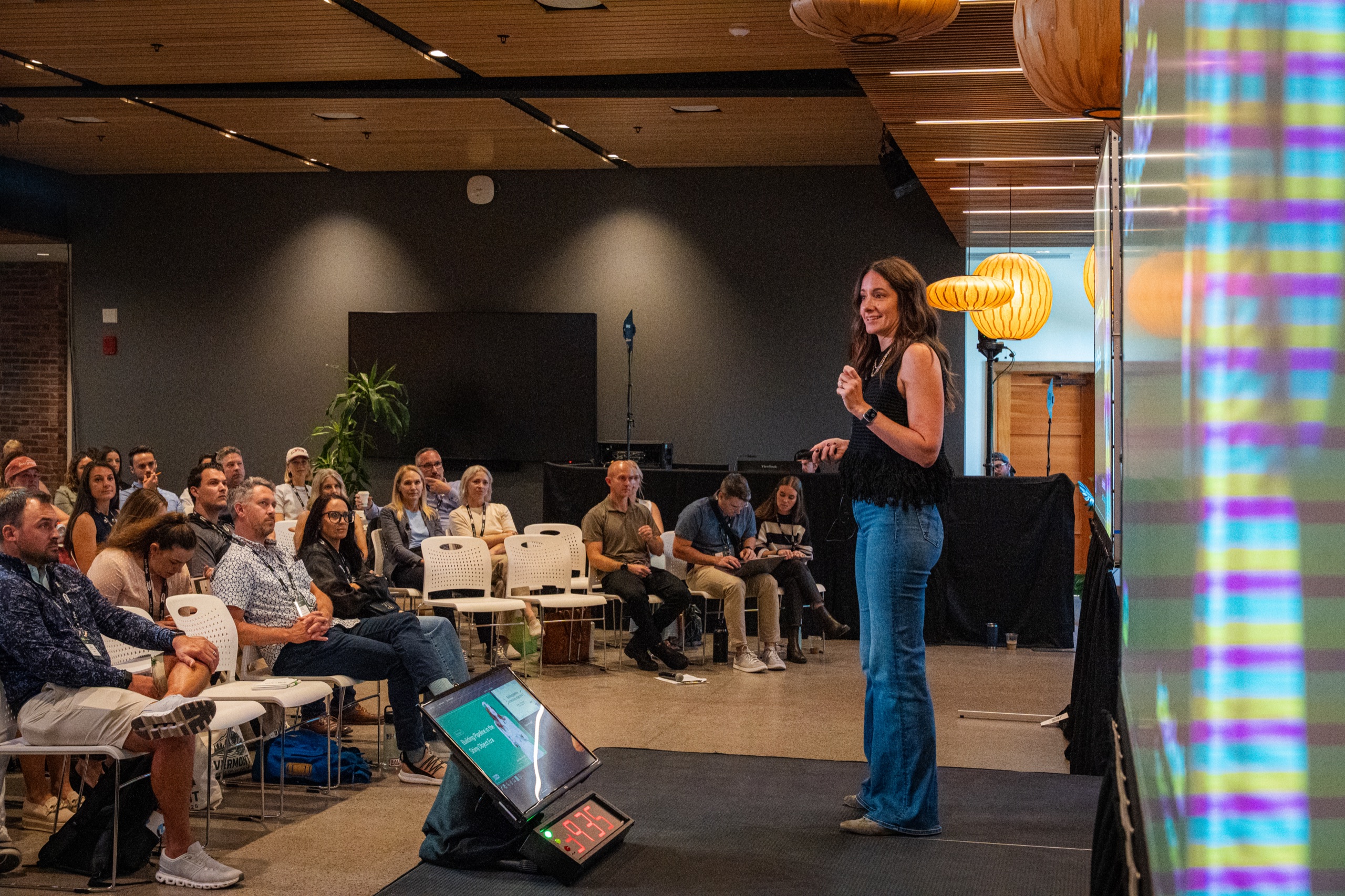 A speaker presenting to a seated audience at an Exit Five conference