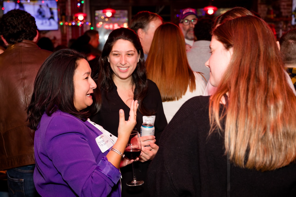 Guests laughing together at a past Exit Five meetup.