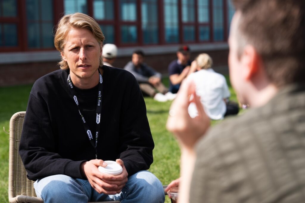 Marketers meeting with coffee outdoors.