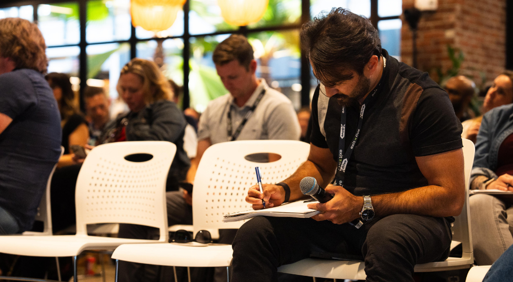 Audience member taking notes during event