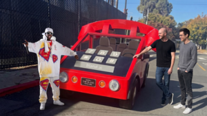 Man beside oversized cartoonish car