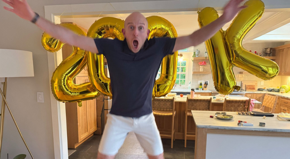 Person celebrating with large balloons